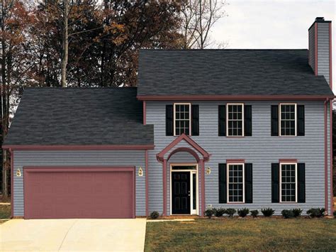 dark gray house with metal roof|grey house with black awnings.